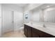 Bathroom featuring double sinks with dark cabinets and a large mirror at 25154 W Wier Ave, Buckeye, AZ 85326