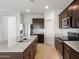 Spacious kitchen featuring stainless steel appliances, granite countertops, and dark wood cabinets at 25154 W Wier Ave, Buckeye, AZ 85326