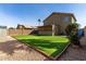 Backyard showcasing green turf, gravel, and a covered patio attached to the home at 2546 E Camellia Dr, Gilbert, AZ 85296