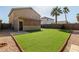 Backyard featuring green turf, gravel landscaping, and a covered patio at 2546 E Camellia Dr, Gilbert, AZ 85296