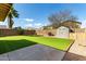 Backyard with green turf, brick wall, storage shed, and a small patio at 2546 E Camellia Dr, Gilbert, AZ 85296