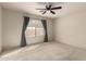 Neutral carpeted bedroom with ceiling fan and window with pleated shades at 2546 E Camellia Dr, Gilbert, AZ 85296