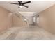 Spacious living room with carpet, fan, and glass stairs leading to the second level at 2546 E Camellia Dr, Gilbert, AZ 85296