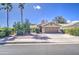 Well-maintained home with desert landscaping featuring mature trees, a two-car garage, and a wide driveway at 2560 S Rowen --, Mesa, AZ 85209