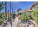 Well-maintained walkway showcasing desert landscaping with rocks and cacti leading to front entrance at 2560 S Rowen --, Mesa, AZ 85209