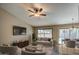 Bright living room featuring stylish furniture, a ceiling fan, and a large window with backyard views at 2560 S Rowen --, Mesa, AZ 85209