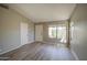 Bright, open living room featuring neutral paint, plank flooring, and ample natural light from a large window at 2560 S Rowen --, Mesa, AZ 85209