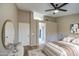 Bedroom with neutral color scheme, ceiling fan, decor, and view into the primary bathroom at 2560 S Rowen --, Mesa, AZ 85209