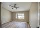 Spacious bedroom with neutral walls, ceiling fan and a window that provides plenty of natural light at 2560 S Rowen --, Mesa, AZ 85209