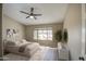 Comfortable main bedroom with neutral color scheme, ceiling fan, and a view to the outdoors at 2560 S Rowen --, Mesa, AZ 85209