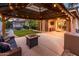 Spacious backyard featuring a covered patio, hot tub, putting green, and outdoor seating areas at 2678 S 172Nd Dr, Goodyear, AZ 85338