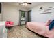 Cozy bedroom with a twin bed and a pink chair, ideal for a young  at 2678 S 172Nd Dr, Goodyear, AZ 85338