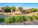 Well-manicured community entrance with stone signage and attractive landscaping at 2678 S 172Nd Dr, Goodyear, AZ 85338