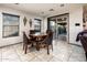 Cozy dining area with wood table, chairs, tile flooring, and sliding glass doors to the patio at 2678 S 172Nd Dr, Goodyear, AZ 85338