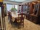 Formal dining room with elegant wood furniture, decorative china cabinets, and natural light at 2678 S 172Nd Dr, Goodyear, AZ 85338