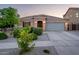 Charming single-story home with a well-maintained front yard, desert landscaping, and two car garage at 2678 S 172Nd Dr, Goodyear, AZ 85338
