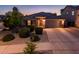 Charming home featuring a well-manicured front yard, mature trees, and a spacious two-car garage at 2678 S 172Nd Dr, Goodyear, AZ 85338