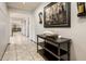 Inviting hallway with neutral tile flooring, a console table, and stylish wall decor at 2678 S 172Nd Dr, Goodyear, AZ 85338