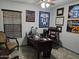 Comfortable home office decorated with sports memorabilia and a large wooden desk and tile floors at 2678 S 172Nd Dr, Goodyear, AZ 85338