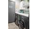 Well-organized laundry room with modern washer and dryer, storage cabinets, and countertop space at 2678 S 172Nd Dr, Goodyear, AZ 85338