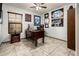 Home office with a dark wood desk, ceiling fan, and sports memorabilia on the walls at 2678 S 172Nd Dr, Goodyear, AZ 85338