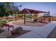 Community playground features a covered play structure, picnic tables, benches, and landscaped walkways at 2678 S 172Nd Dr, Goodyear, AZ 85338