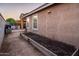 Side yard with retaining wall and patio with outdoor grill under covered patio at 2678 S 172Nd Dr, Goodyear, AZ 85338