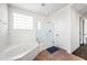 Bright bathroom showcasing a soaking tub, glass enclosed shower, and a privacy block window for natural light at 2741 E Bridgeport Pkwy, Gilbert, AZ 85295