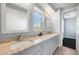 Bathroom featuring double sinks with granite countertops and gray cabinets at 2741 E Bridgeport Pkwy, Gilbert, AZ 85295