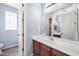 Bathroom with a wood vanity, mirror, window, and neutral walls at 2741 E Bridgeport Pkwy, Gilbert, AZ 85295