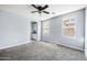 A serene bedroom features soft blue walls, plush carpet, and natural light streaming through the windows at 2741 E Bridgeport Pkwy, Gilbert, AZ 85295