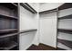 Well-organized walk-in closet featuring dark wood shelving and rods for clothing, maximizing storage potential at 2741 E Bridgeport Pkwy, Gilbert, AZ 85295