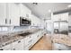 A modern kitchen features white cabinets, granite countertops, stainless steel appliances, and ample cabinet space at 2741 E Bridgeport Pkwy, Gilbert, AZ 85295