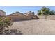 Expansive backyard featuring desert landscaping and a sturdy block wall for privacy and security at 3001 E Amber Ridge Way, Phoenix, AZ 85048