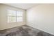 Cozy bedroom with neutral-toned walls and carpet with a window providing natural light at 3001 E Amber Ridge Way, Phoenix, AZ 85048