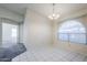 A dining room features a chandelier, white tiled floors, and a large window at 3001 E Amber Ridge Way, Phoenix, AZ 85048