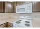 Close-up view of the kitchen featuring white appliances and modern microwave at 3001 E Amber Ridge Way, Phoenix, AZ 85048