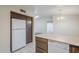 Open kitchen featuring white appliances, overhead storage, and an open layout into the dining room at 3001 E Amber Ridge Way, Phoenix, AZ 85048