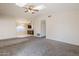 Inviting living room with carpet, vaulted ceiling, and seamless access to the kitchen at 3001 E Amber Ridge Way, Phoenix, AZ 85048