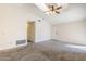 Bright living room featuring vaulted ceilings, plush carpet, and skylight at 3001 E Amber Ridge Way, Phoenix, AZ 85048