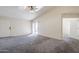 Open and airy living room with carpet, vaulted ceiling, access to front entry and patio at 3001 E Amber Ridge Way, Phoenix, AZ 85048