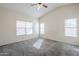 This main bedroom features neutral carpet, white walls, and three large windows at 3001 E Amber Ridge Way, Phoenix, AZ 85048