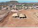 Aerial view of new house framed on a lot with a partial fence, mountain backdrop and blue sky at 33402 N 142Nd Way, Scottsdale, AZ 85262