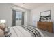 Bright bedroom featuring a large window, neutral walls, and a stylish dresser with curated decor accents at 33414 N 142Nd Way, Scottsdale, AZ 85262