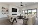 Stylish living room with modern fireplace, built-ins, and sliding glass doors at 33414 N 142Nd Way, Scottsdale, AZ 85262