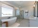 Elegant bathroom showcasing a standalone tub, glass-enclosed shower, and a stylish vanity at 33417 N 142Nd Way, Scottsdale, AZ 85252