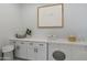 Modern laundry room featuring white cabinetry, stylish decor, a front load washer/dryer and neutral paint at 33417 N 142Nd Way, Scottsdale, AZ 85252