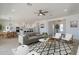 Spacious open-concept living room seamlessly connecting the dining and kitchen areas, with modern decor at 33417 N 142Nd Way, Scottsdale, AZ 85252