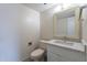 Cozy half bathroom with marble countertop, decorative mirror, and a toilet at 3823 N 28Th St, Phoenix, AZ 85016