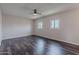 Spacious bedroom with wood floors, ceiling fan, and two windows providing natural light at 3823 N 28Th St, Phoenix, AZ 85016